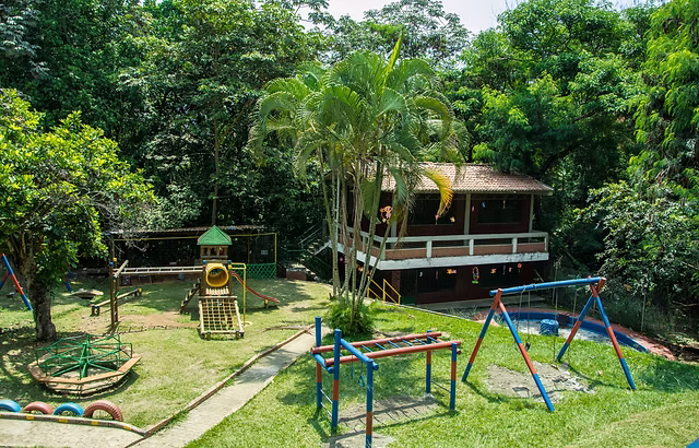 School playground and classroom building surrounded by greenery